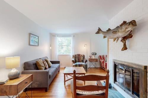 a living room with a couch and a fireplace at Oak Leaf Cape Cottage in Oak Bluffs