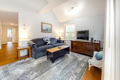 a living room with a couch and a tv at Ferry Harbor Cottage in Falmouth