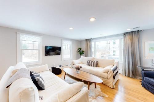 a living room with two white couches and a table at Island Home in Vineyard Haven