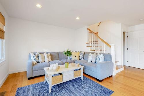 a living room with a couch and a table at Modern Beach & Town Getaway in Falmouth