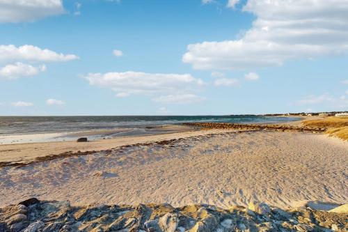 a sandy beach with the ocean in the background at Sandbar Hideaway in Falmouth