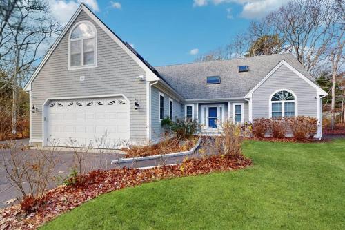 a large white house with a garage at Sandbar Hideaway in Falmouth