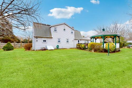 a house with a gazebo in front of a yard at Coastal Charm on the Cape in Centerville