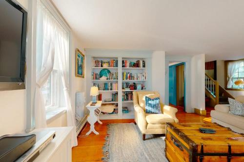 a living room with a couch and a tv at Salty Ridge Station in Orleans