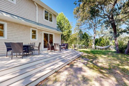 a deck with a table and chairs on a house at Set Sail in Oak Bluffs