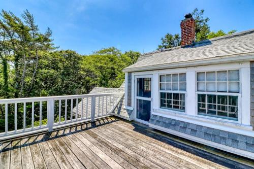 a house with a wooden deck with a house at Beachroad Hideout in Lobsterville
