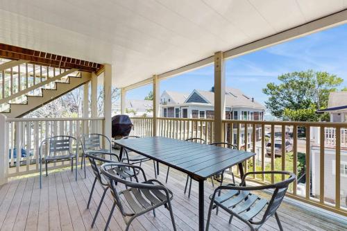 a table and chairs on a balcony with a view of a house at The Grey Lady in Provincetown