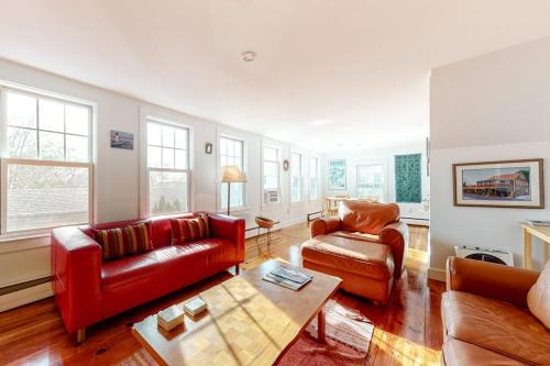 a living room with two couches and a table at Cape Point Escape in Provincetown