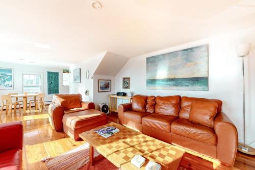 a living room with a couch and a table at Cape Point Escape in Provincetown