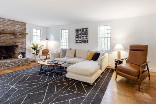 a living room with a couch and a fireplace at Wellfleet Harbor Hideaway in Wellfleet