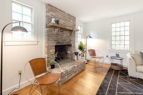 a living room with a brick fireplace and a couch at Wellfleet Harbor Hideaway in Wellfleet