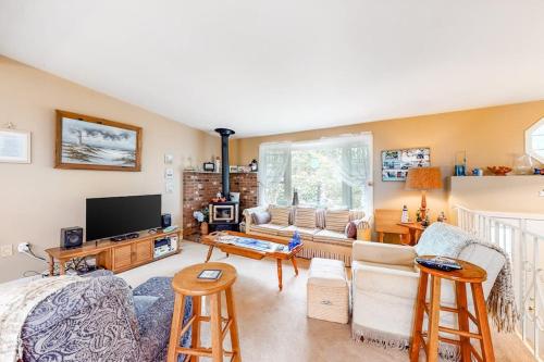 a living room with a couch and a tv at Summer Daze in Edgartown