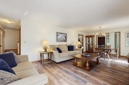 a living room with a couch and a table at Fallen Oak Retreat in Oak Bluffs
