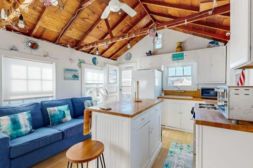 a kitchen and a living room with a blue couch at Beach Days in Dennis Port