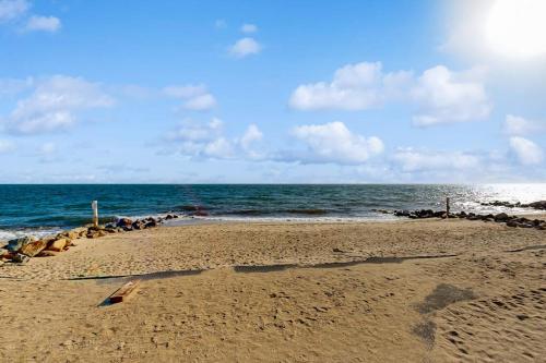 a beach with a bunch of rocks and the ocean at Beach Days in Dennis Port
