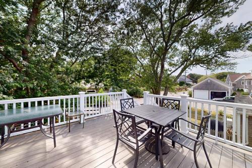a wooden deck with a table and chairs on it at Provincetown Bliss in Provincetown