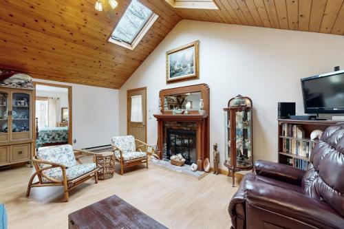 a living room with a couch and a fireplace at C-Haven in West Tisbury