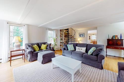 a living room with a couch and a table at Saltwater Haven in Orleans