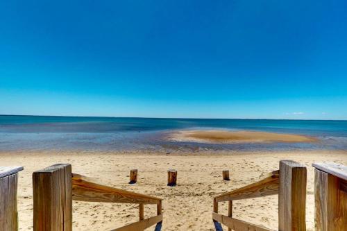 a view of the beach from a wooden pier at Beach Blessing in Provincetown