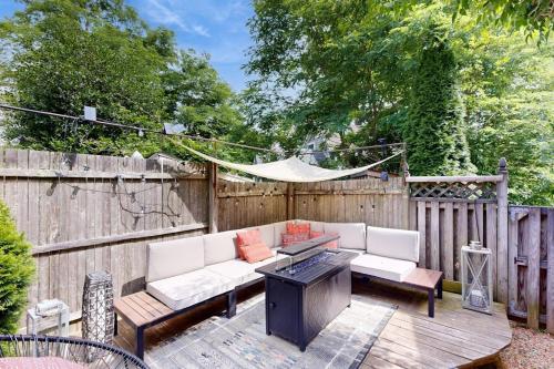 a patio with a couch and a table and a fence at Sankofa House in Oak Bluffs