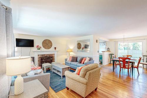 a living room with a couch and a table at Falmouth Beach House in Falmouth