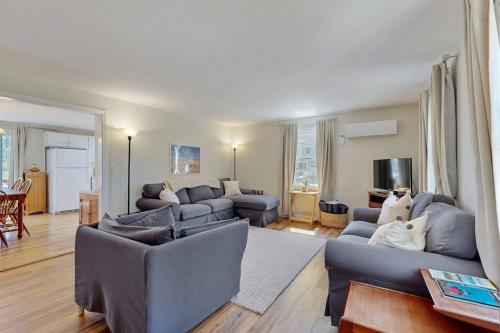 a living room with two couches and a living room with at Peace & Serenity in Falmouth