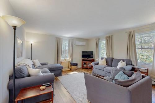 a living room with two couches and a tv at Peace & Serenity in Falmouth