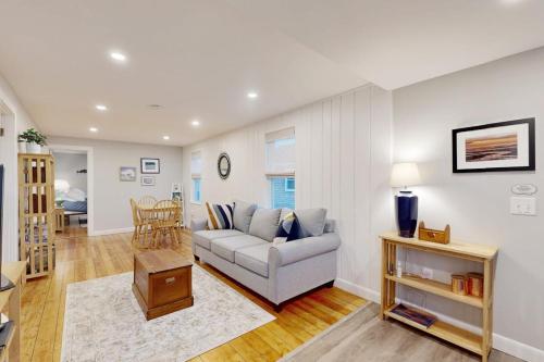 a living room with a couch and a table at Seabreeze Escape in Barnstable