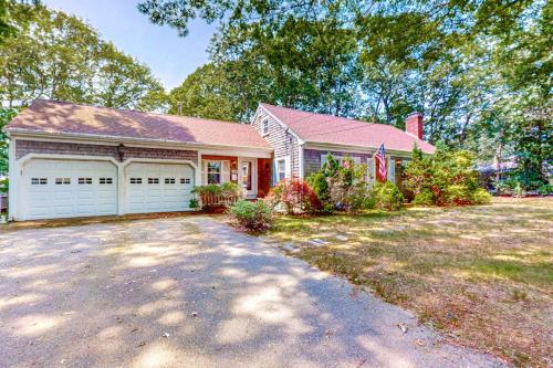 a house with a garage and a driveway at Falmouth Beachtown Getaway in Falmouth