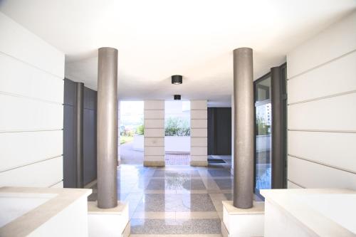 a rendering of a hallway with columns in a building at Guest House Marco Polo in Vicenza