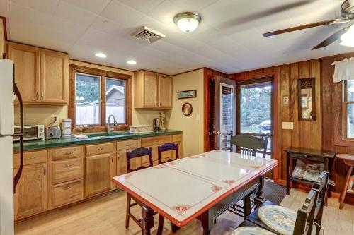 a kitchen with wooden cabinets and a table with chairs at Eastham Escape in North Eastham