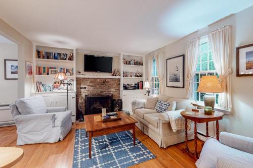 a living room filled with furniture and a fireplace at Island Oasis in Edgartown
