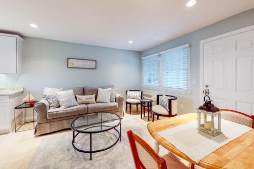 a living room with a couch and a table at Immaculate Beach Condo in Dennis Port