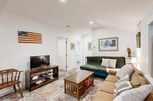 a living room with a couch and a tv at Gateway to Cape Cod in West Yarmouth