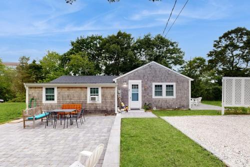 a small house with a patio and a table at Gateway to Cape Cod in West Yarmouth