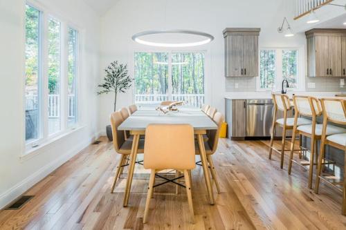 a kitchen and dining room with a table and chairs at Peace Among the Pines in Wellfleet