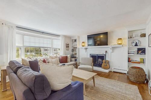 a living room with a couch and a fireplace at Strawberry Hill Haven in Hyannis