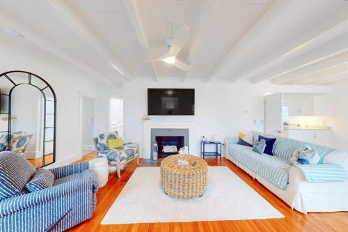 a living room with two couches and a fireplace at Golden Slumbers in Bourne