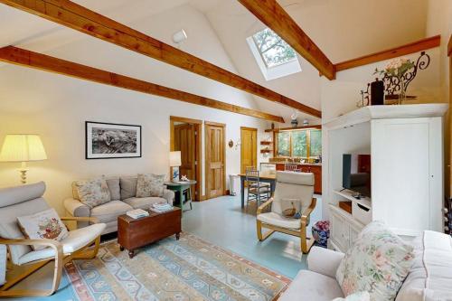 a living room with a couch and a fireplace at Chilmark Guest House in Chilmark