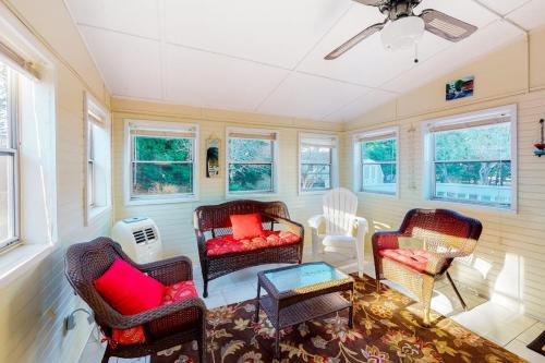 a living room with chairs and a ceiling fan at Stop And Relax in Ocean Pines