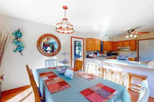 a dining room with a blue table and a kitchen at Dove Lane 8 in Ocean Pines