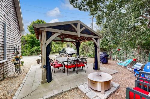 a gazebo with a table and chairs on a patio at Bird Street Breeze in Oak Bluffs