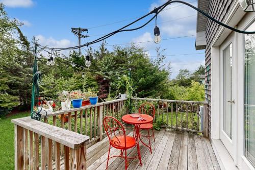 a wooden deck with a table and chairs on it at Bird Street Breeze in Oak Bluffs
