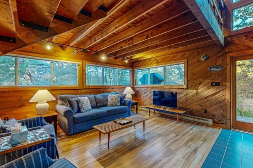 a living room with a couch and a tv at Cozy Island Cabin in Edgartown