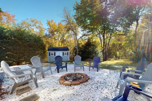 a group of chairs sitting around a fire pit at Briarcliff Bliss in Barnstable