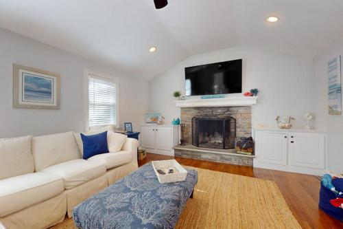 a living room with a couch and a fireplace at Briarcliff Bliss in Barnstable