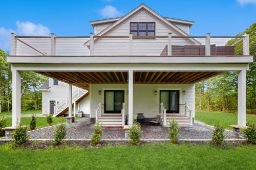 a large white house with a large porch at Heritage Escape in Mashpee