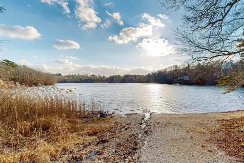 a body of water with trees and clouds in the sky at Pond View Getaway in Sandwich