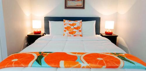 a bedroom with a bed with oranges on it at The Duo- Myles & Paul in Provincetown