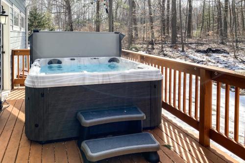 a hot tub on a deck with a stool at Friendly Farms in Lakeside